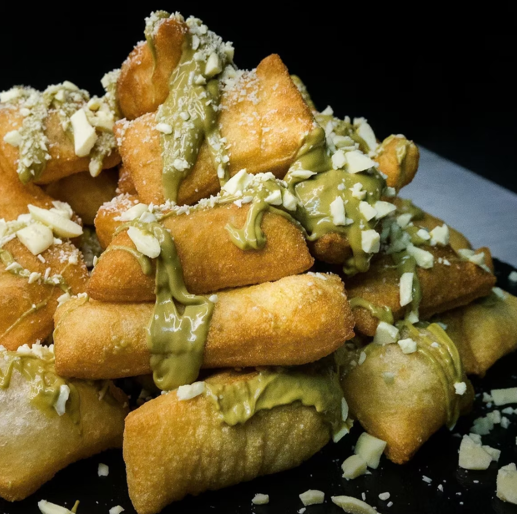 Golden fried pastries with pistachio cream and white chocolate